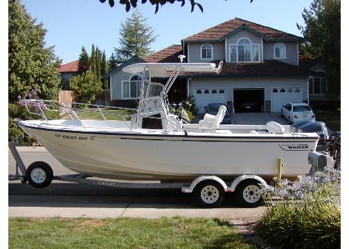 Atlantic Towers T-Top installed on a Boston Whaler Outrage boat, parked in a driveway with a house in the background.