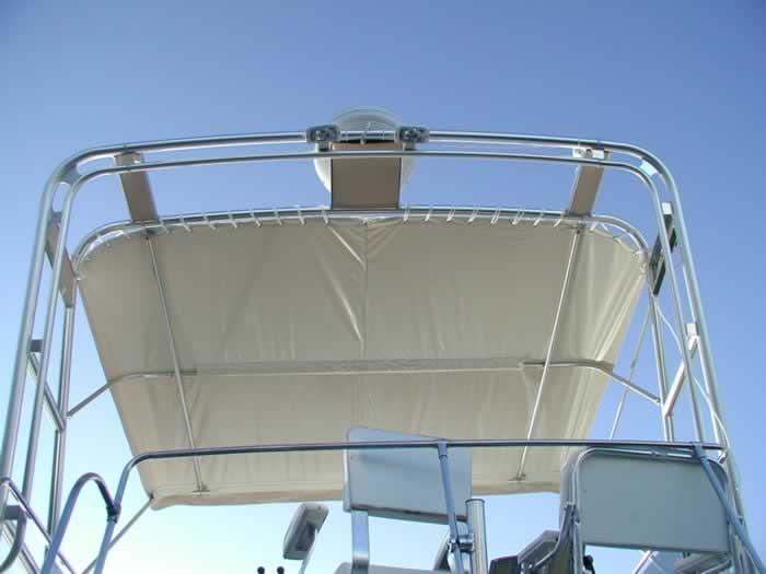 Atlantic Towers boat tower with a beige canvas shade against a clear blue sky, viewed from below.