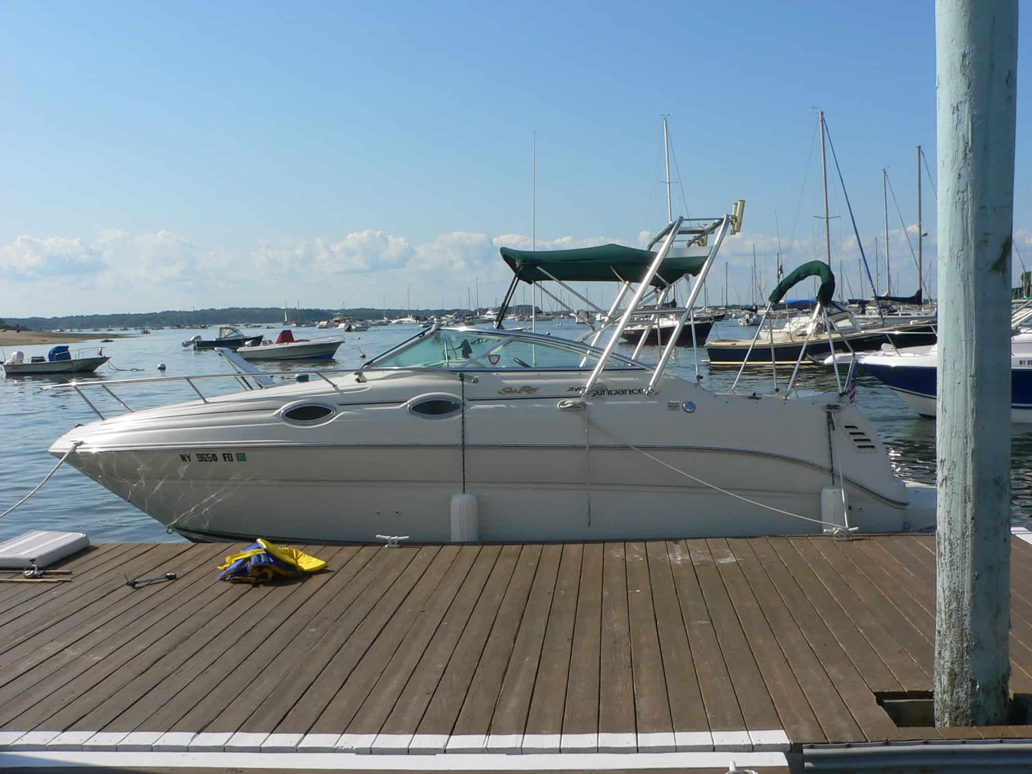 Atlantic Towers arch installed on a Sea Ray 240 Sundancer cuddy boat with a white hull and tinted windows