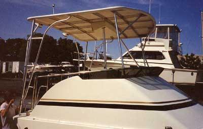Atlantic Towers Top installed on the cabin of an Egg Harbor 38 Golden Egg boat docked near other vessels.