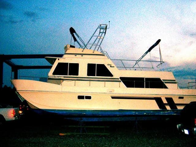 Holiday Mansion 38 Coastal Barracuda boat displaying Atlantic Towers Arch mounted on top at dusk outdoors.