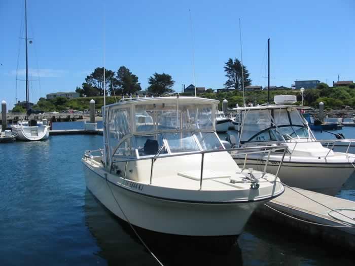 Atlantic Towers Uncategorized boat docked at a marina with clear blue sky and other boats nearby in the background