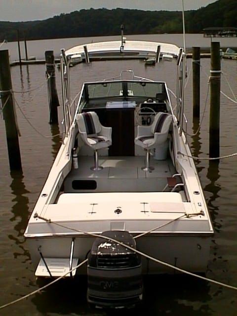 Atlantic Towers Top installed on a Wellcraft 250 Sportsman boat at a dock beside calm water.