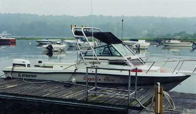 Atlantic Towers arch installed on a Stratos 2250 Walkaround boat at a dock, with other boats visible in the background.