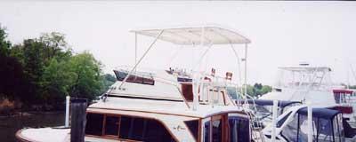 Atlantic Towers Top installed on an Egg Harbor 40 Sedan docked at a marina, with boats and trees in the background.
