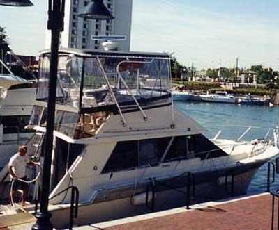 Atlantic Towers Top installed on a Silverton 40 Convertible docked by the waterfront.