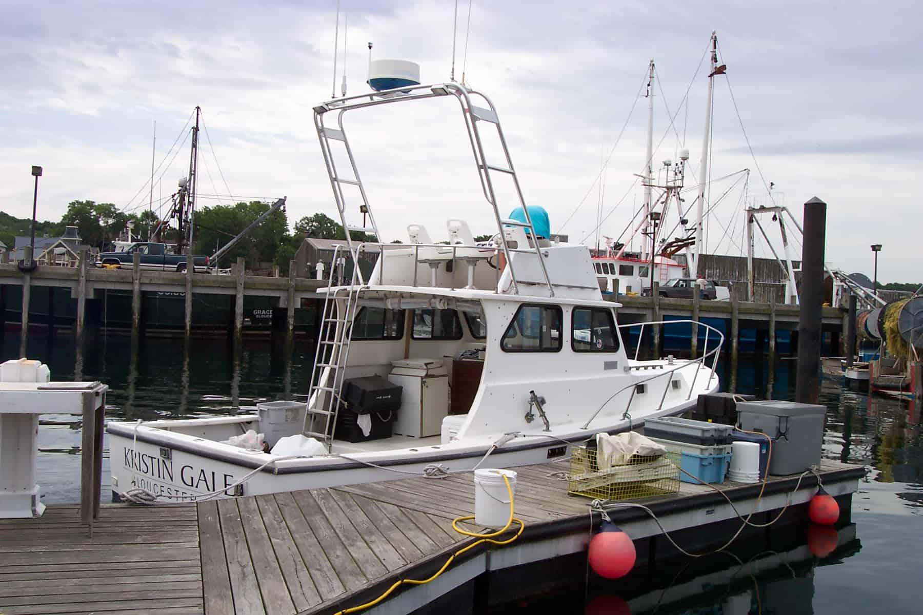 Atlantic Towers Arch installed on a JC 31 FB Casco Bay boat at the marina, surrounded by other boats.