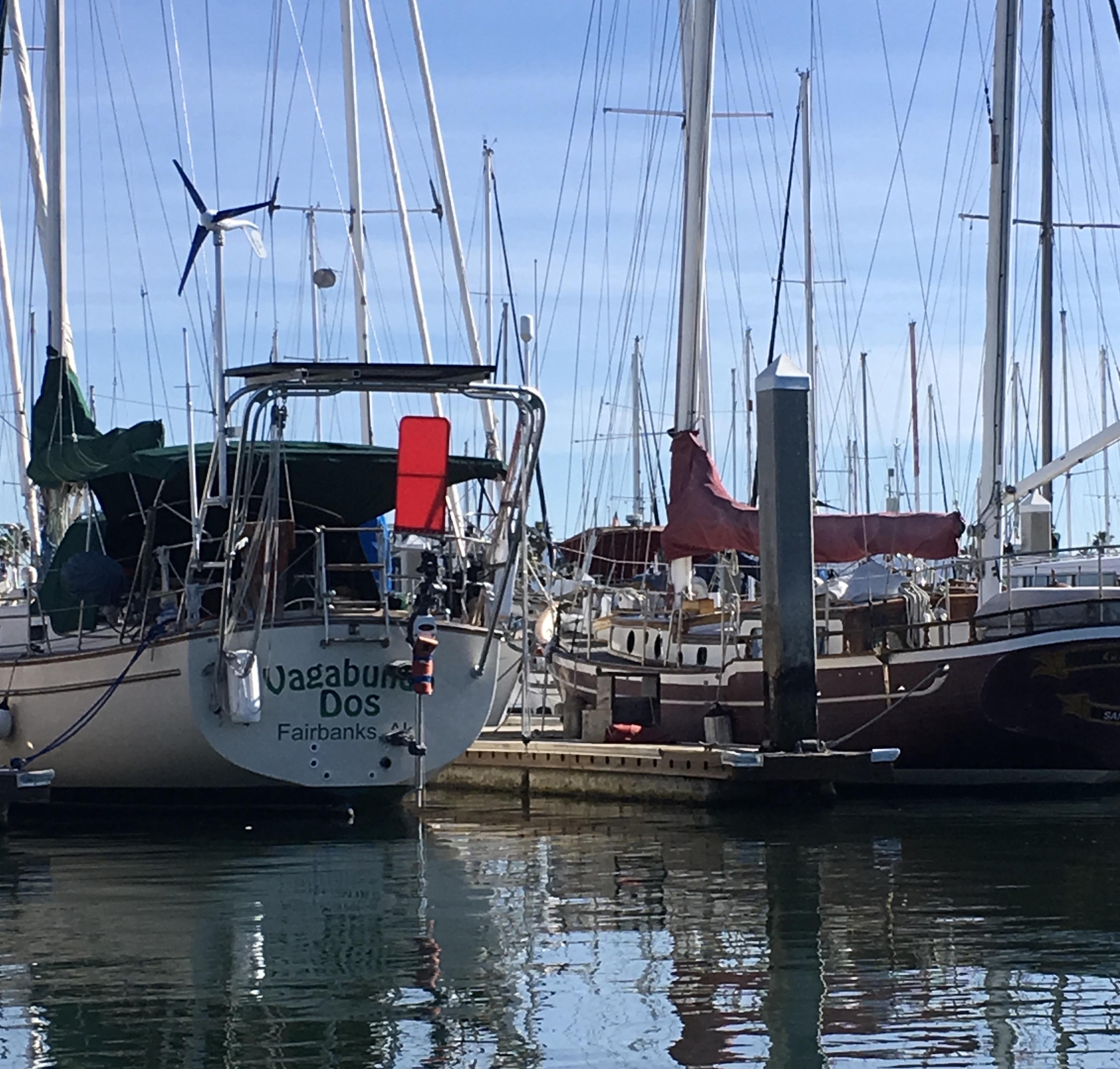 Atlantic Towers Arch installed on a boat named Vagabundo in a marina filled with sailboats and masts.