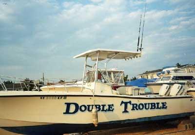 Atlantic Towers T-Top installed on a Mako 254 Console boat named Double Trouble, shown docked on land.