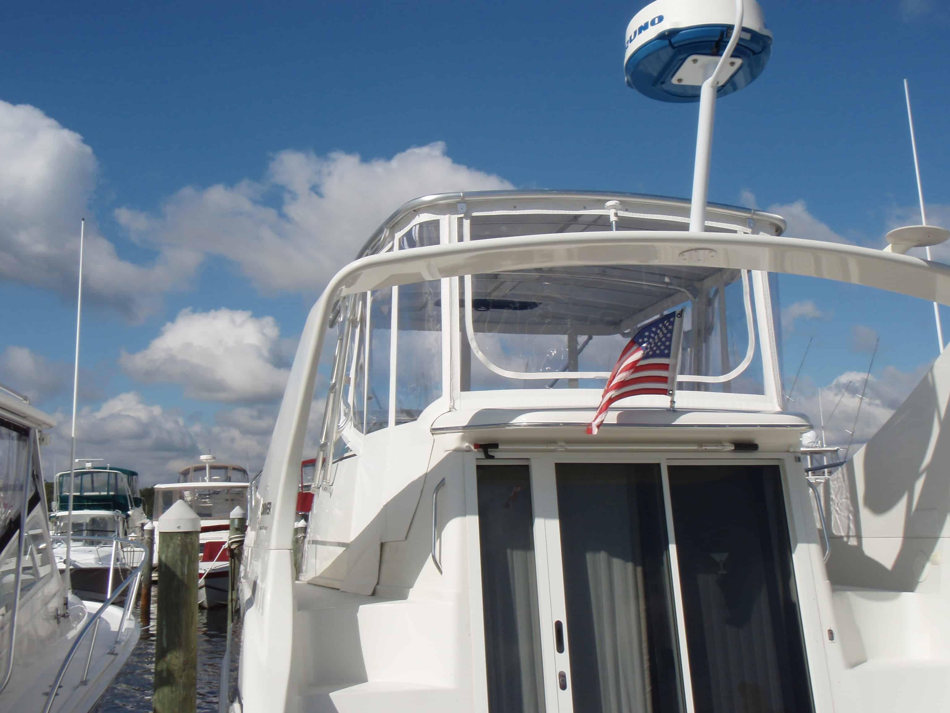 Atlantic Towers Top installed on the rear upper deck of a white Carver 350 Mariner yacht docked in a marina.