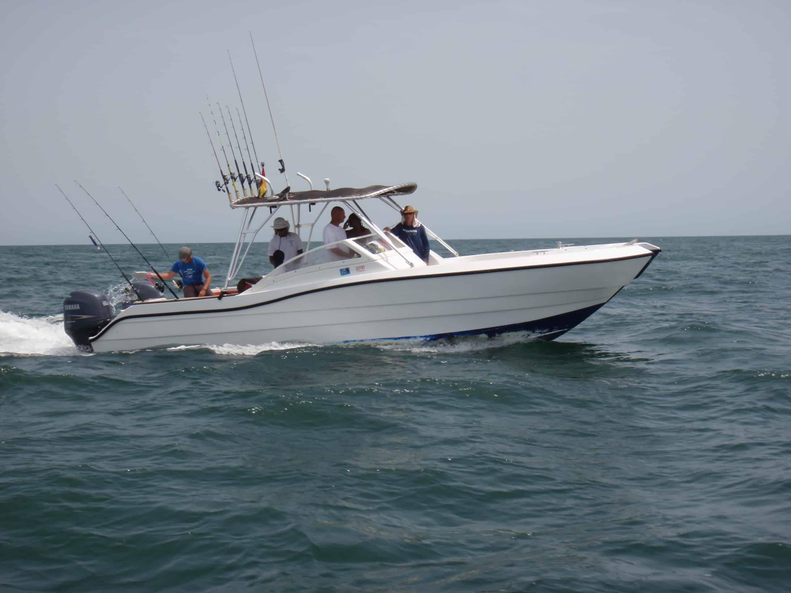 Atlantic Towers Top installed on an Atlantic Evasion 28 bow rider boat, cruising on open water with fishermen aboard.