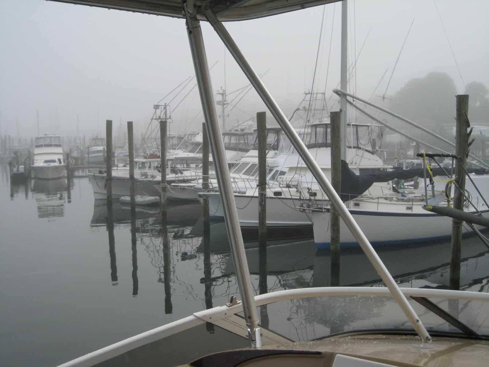 Atlantic Towers Top installed on a Carver 410 Sports Sedan boat shown in a marina during the day.