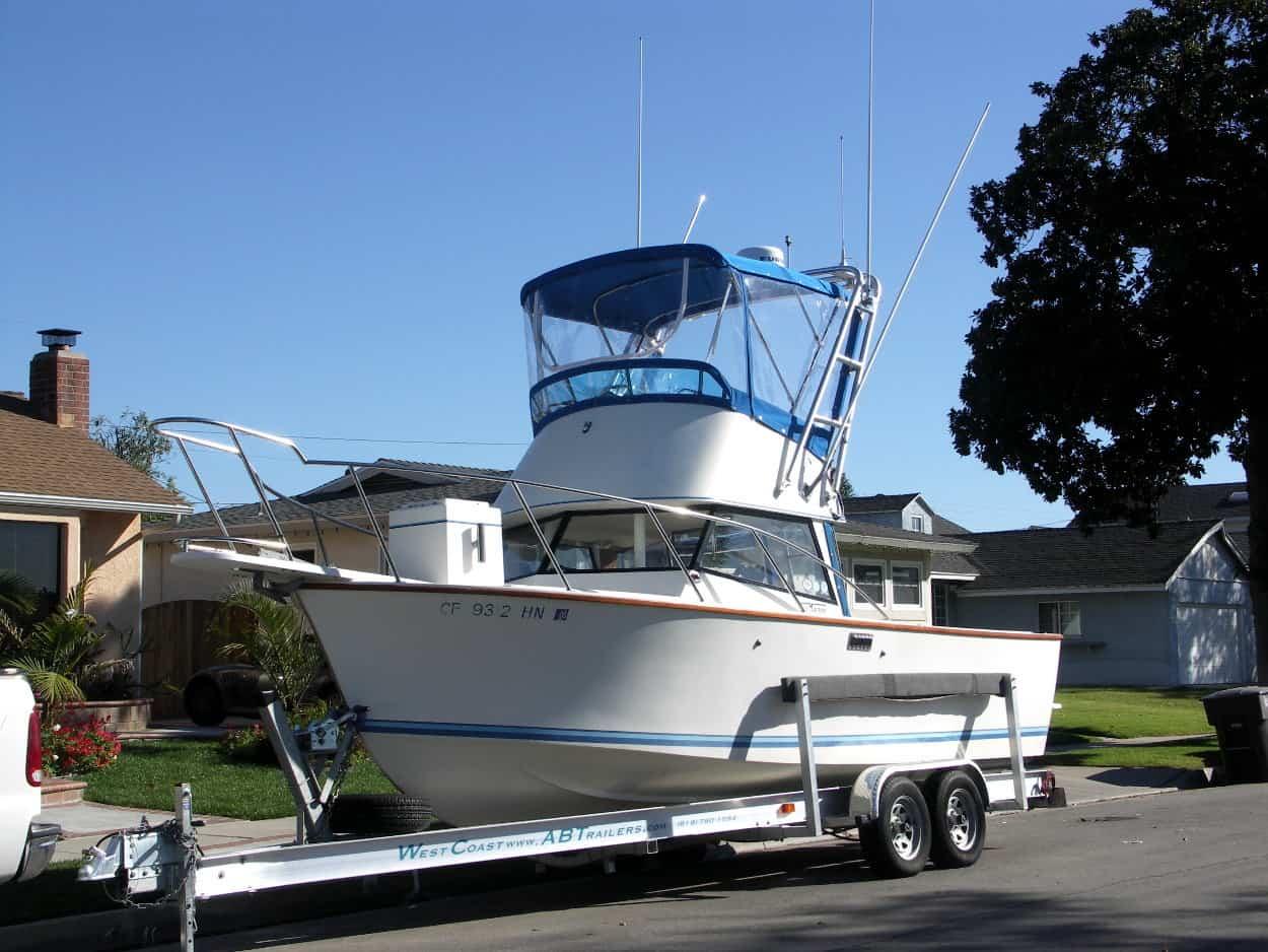 Atlantic Towers Arch installed on a Blackman 23 Billfisher boat, parked on a trailer in a residential area.