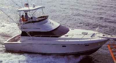 Atlantic Towers Top installed on Silverton 41 Convertible boat cruising on the water with fishing rods mounted.