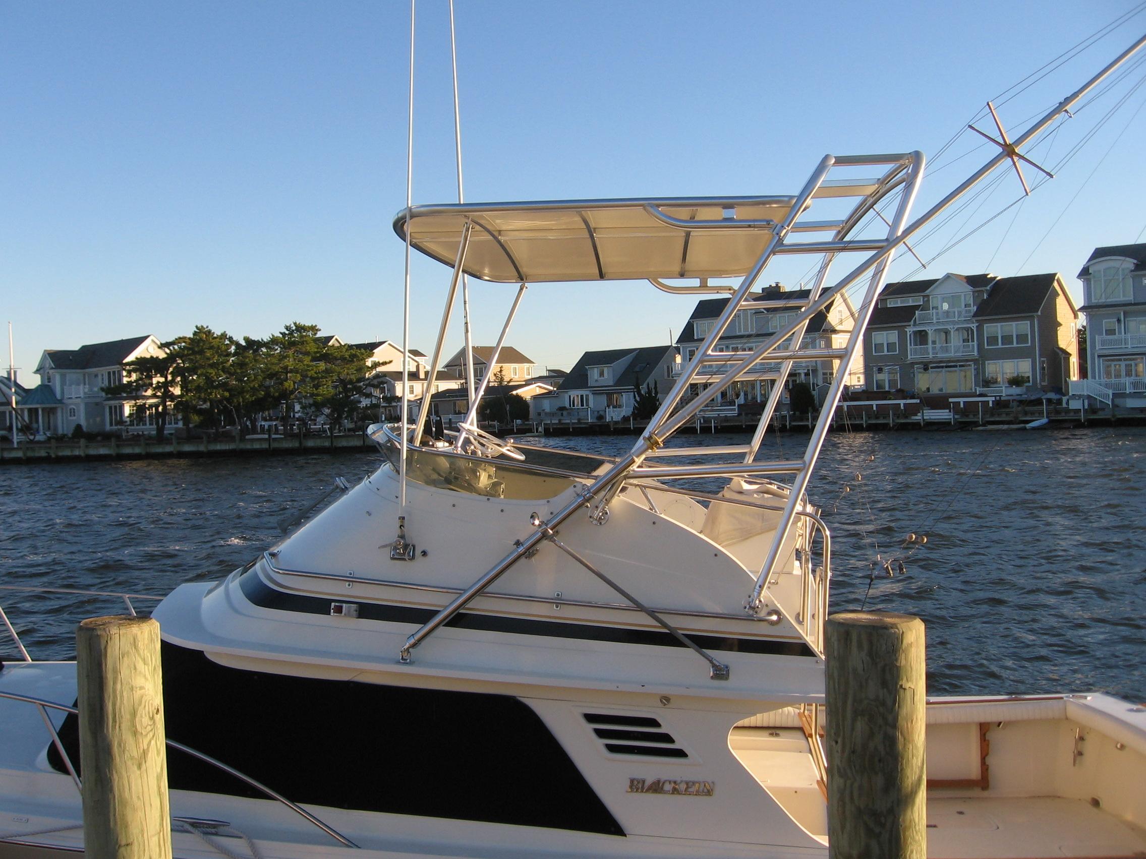 Atlantic Towers Top installed on a Blackfin boat docked by the waterfront with houses in the background.