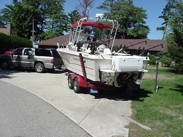 Atlantic Towers Arch on a Starcraft 2314 Walkaround boat parked on a driveway beside a truck.