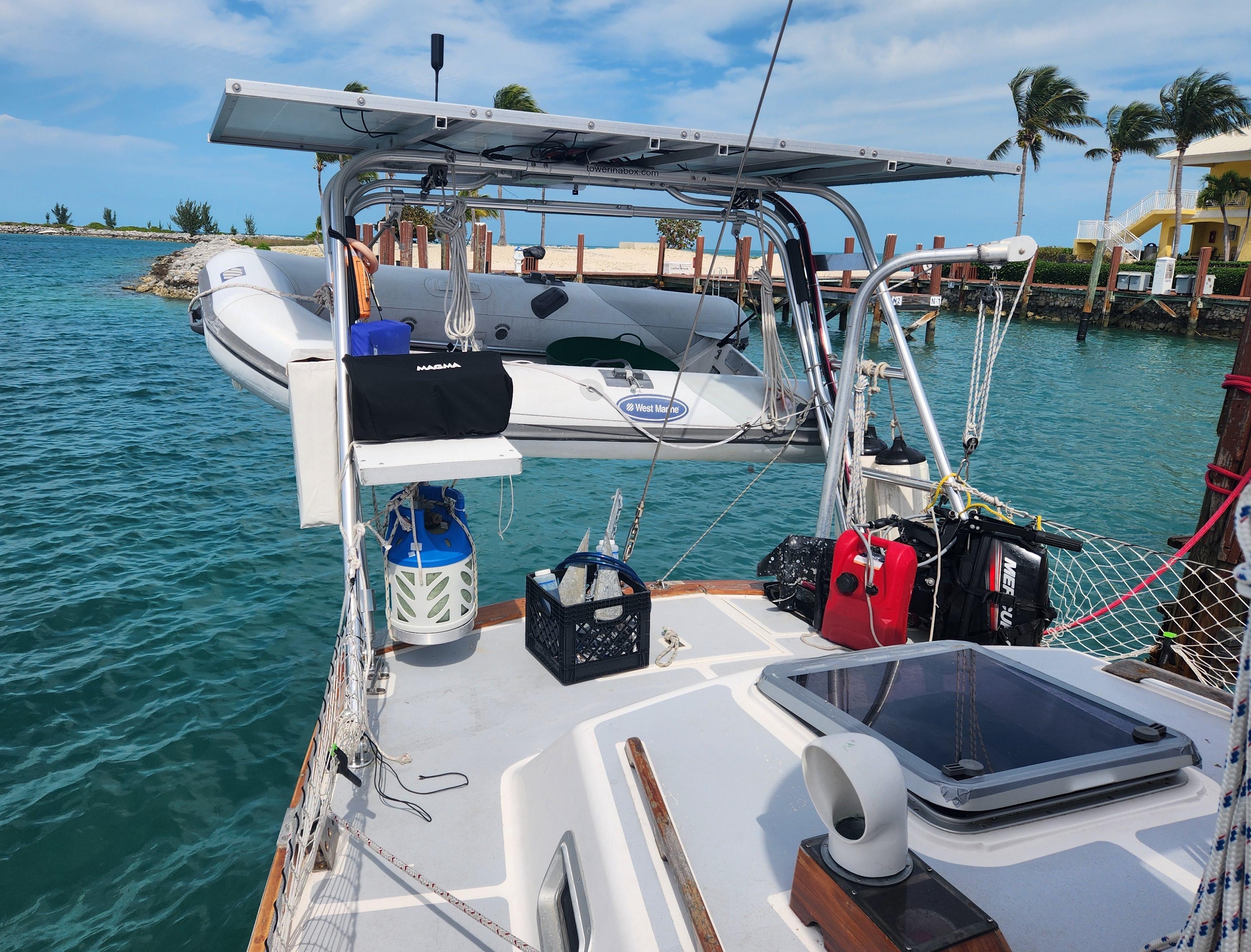 Atlantic Towers Arch installed on a Gulfstar boat with a dinghy and accessories visible. Tropical waters in the background.