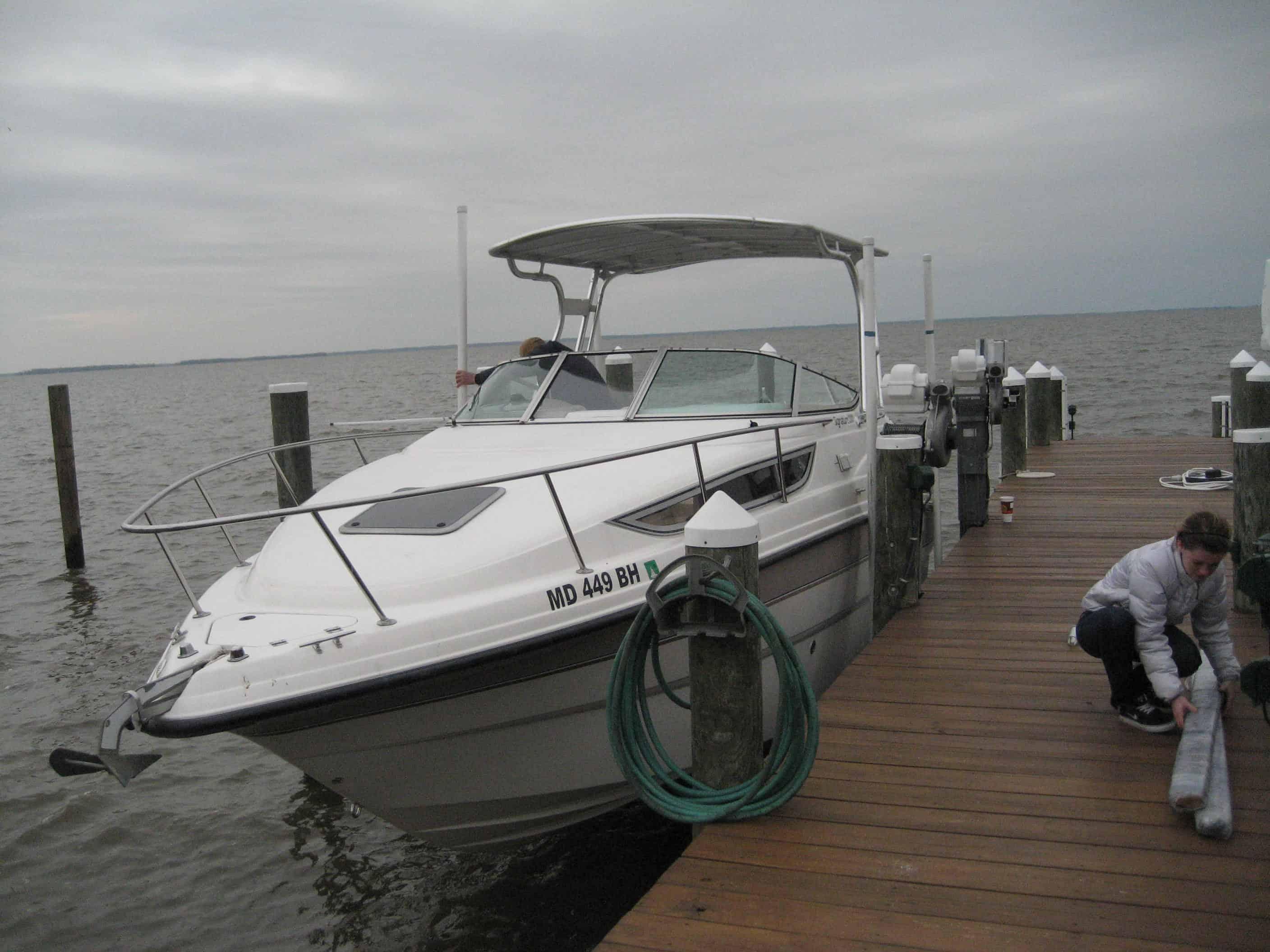 Chaparral boat docked with Atlantic Towers Top installed metal canopy over the cockpit area on a cloudy day