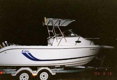 Atlantic Towers Top installed on a white Cobia 220 Walk Around boat on a trailer at night