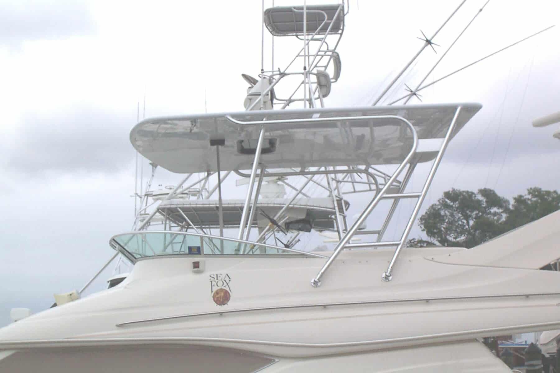 Atlantic Towers Top installed on the Maxum 46 SCB boat with white hull and fishing tower under cloudy sky
