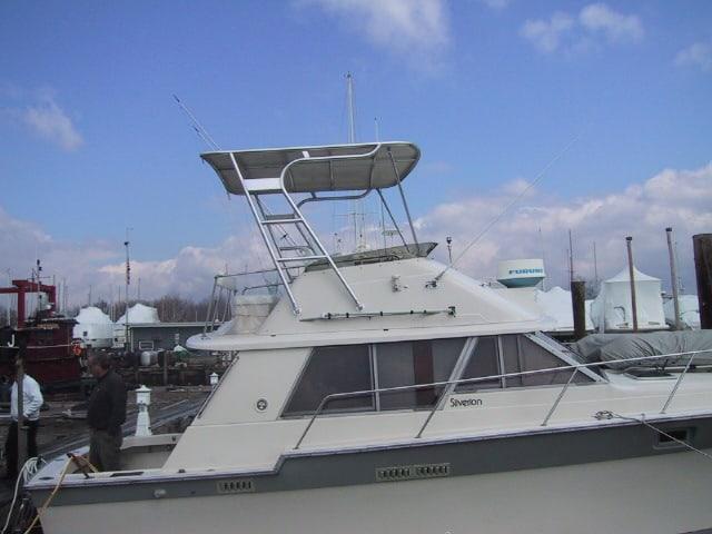 Atlantic Towers Top installed on a Silverton 34C Convertible boat, showing the frame and canvas cover on deck