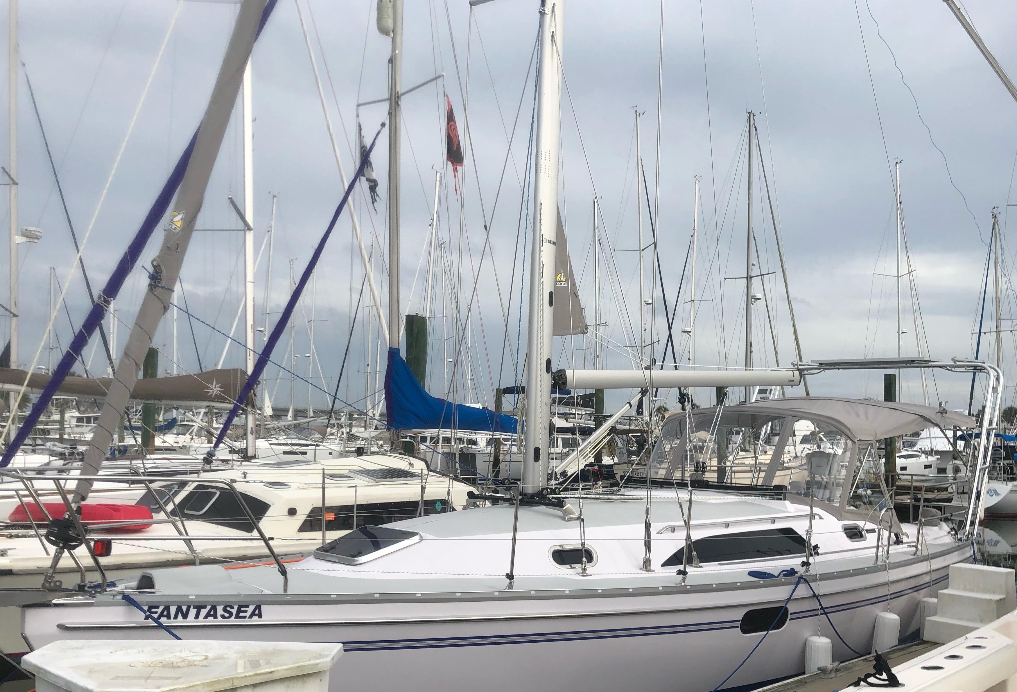Atlantic Towers Arch installed on a Catalina boat docked at a marina, surrounded by various other boats.