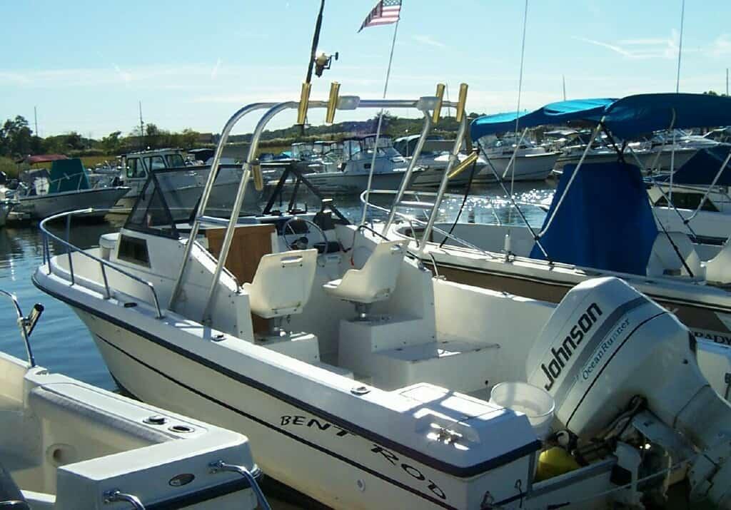 Atlantic Towers arch installed on Angler Boats 220 Walkaround with Johnson outboard engine at marina dock