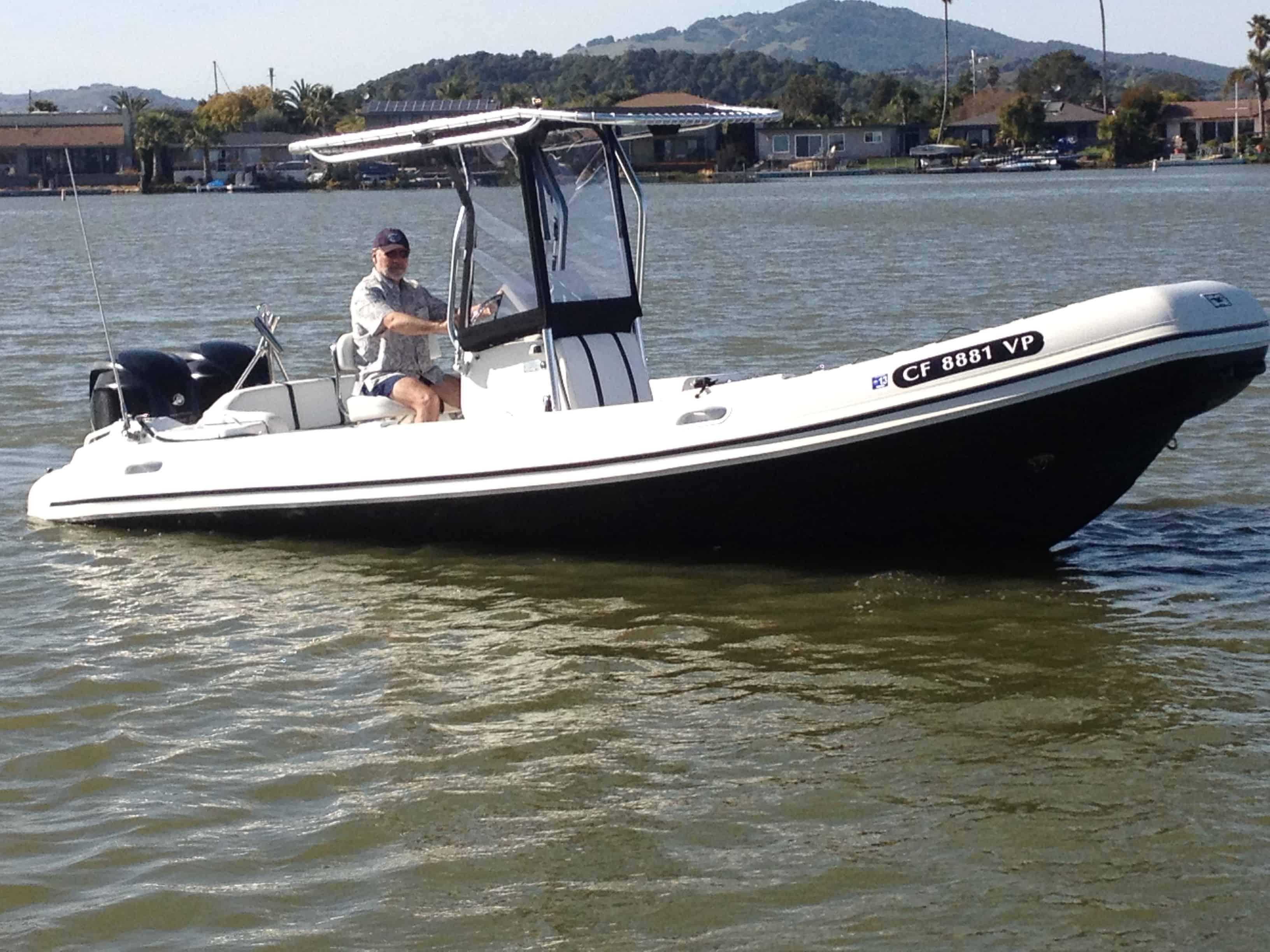 Atlantic Towers T-Top installed on a Nautica 24 RIB boat with a blue hull on calm water.
