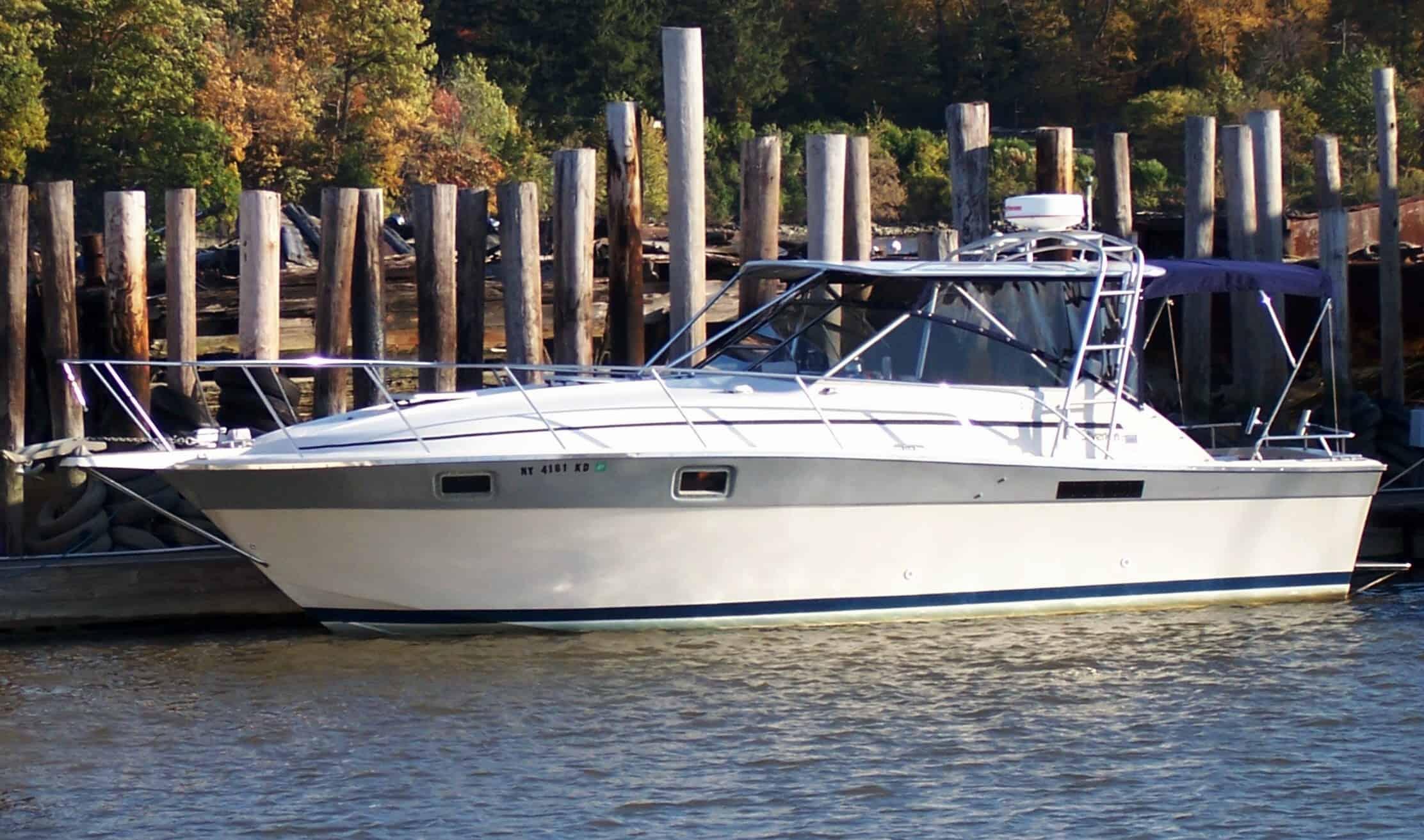 Atlantic Towers top installed on a Silverton 31 Gulfstream boat, docked near wooden pilings by the water.