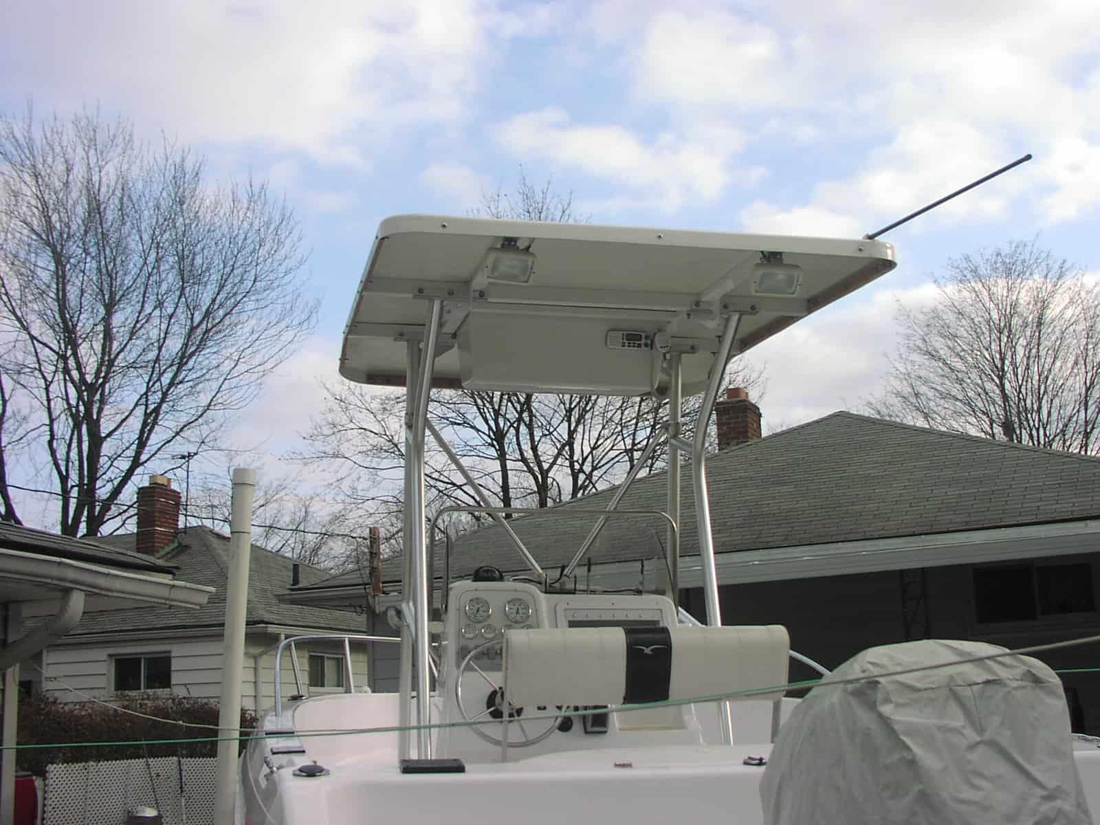 Atlantic Towers T-Top installed on a Pro Line 20 boat with visible steering console and seating under overcast sky.