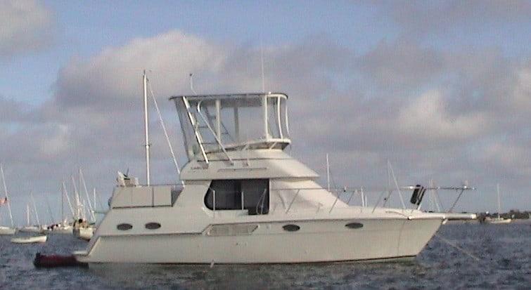Atlantic Towers Top installed on a Carver 325/326 Aft Cabin boat, docked in a marina with other vessels.