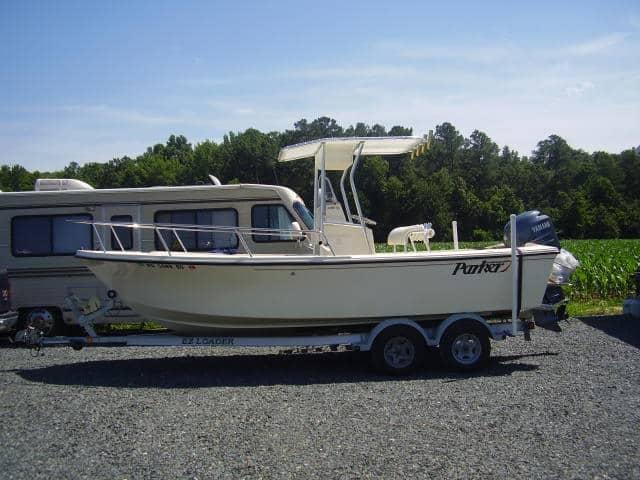 Atlantic Towers T-Top installed on a Parker 21 Center Console boat parked on a gravel surface with surrounding greenery.