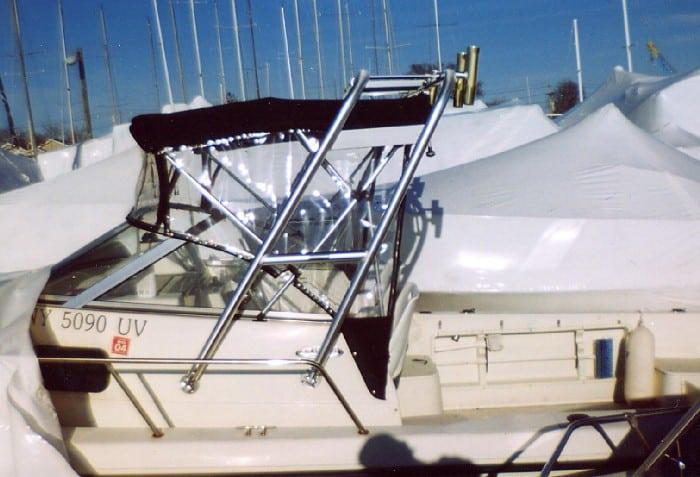 Atlantic Towers Arch installed on a Hydra Sports 210 boat at a marina with covered boats in the background
