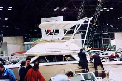 Atlantic Towers Top installed on Tiara 3300 Flybridge yacht at an indoor boat show with several people around.