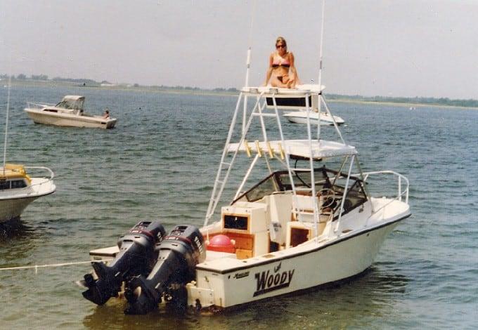 Atlantic Towers Tuna Tower installed on a Mako 258 boat with a person seated on top, surrounded by water.