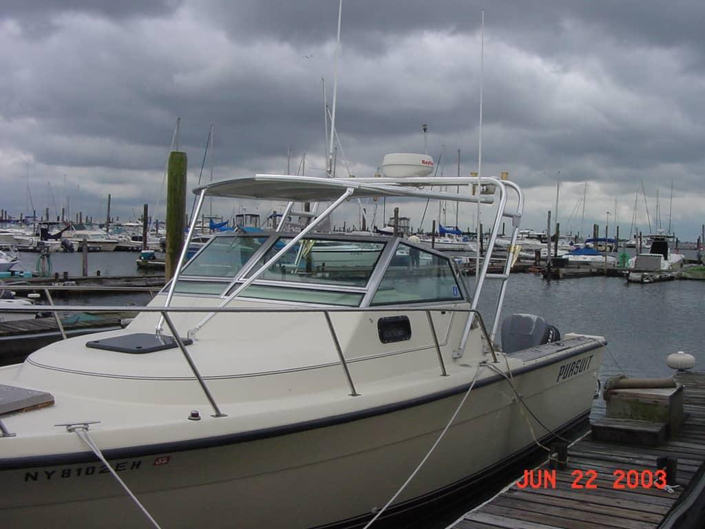 Atlantic Towers Top installed on a Tiara 2600 boat docked at a marina under cloudy skies.