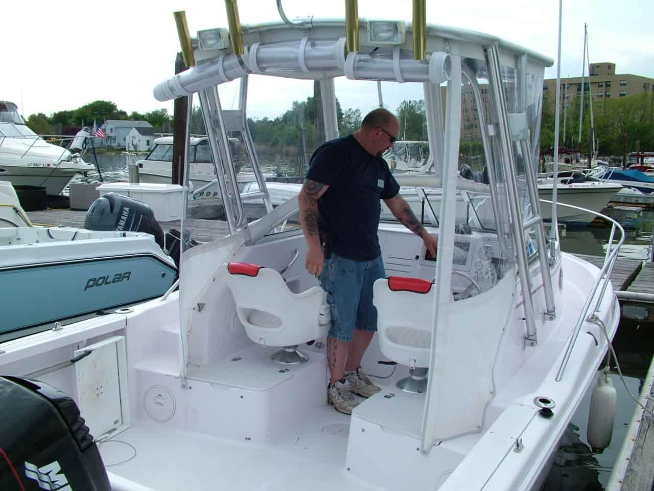 Atlantic Towers Top installed on a Pro Line 201,20/21 Walk boat with a man operating the controls at a marina.