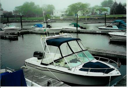 Atlantic Towers arch installed on a Grady White 19 Tournament boat docked in a marina on a cloudy day.