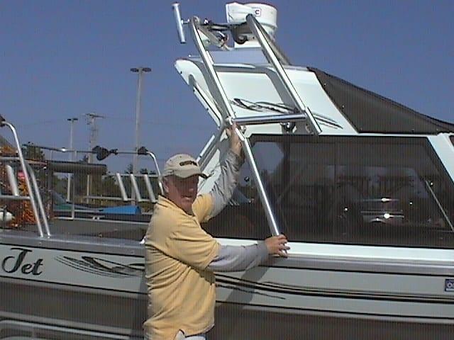 Man holding Atlantic Towers Arch on a Thunder Jet Alexis Classic boat at a marina.