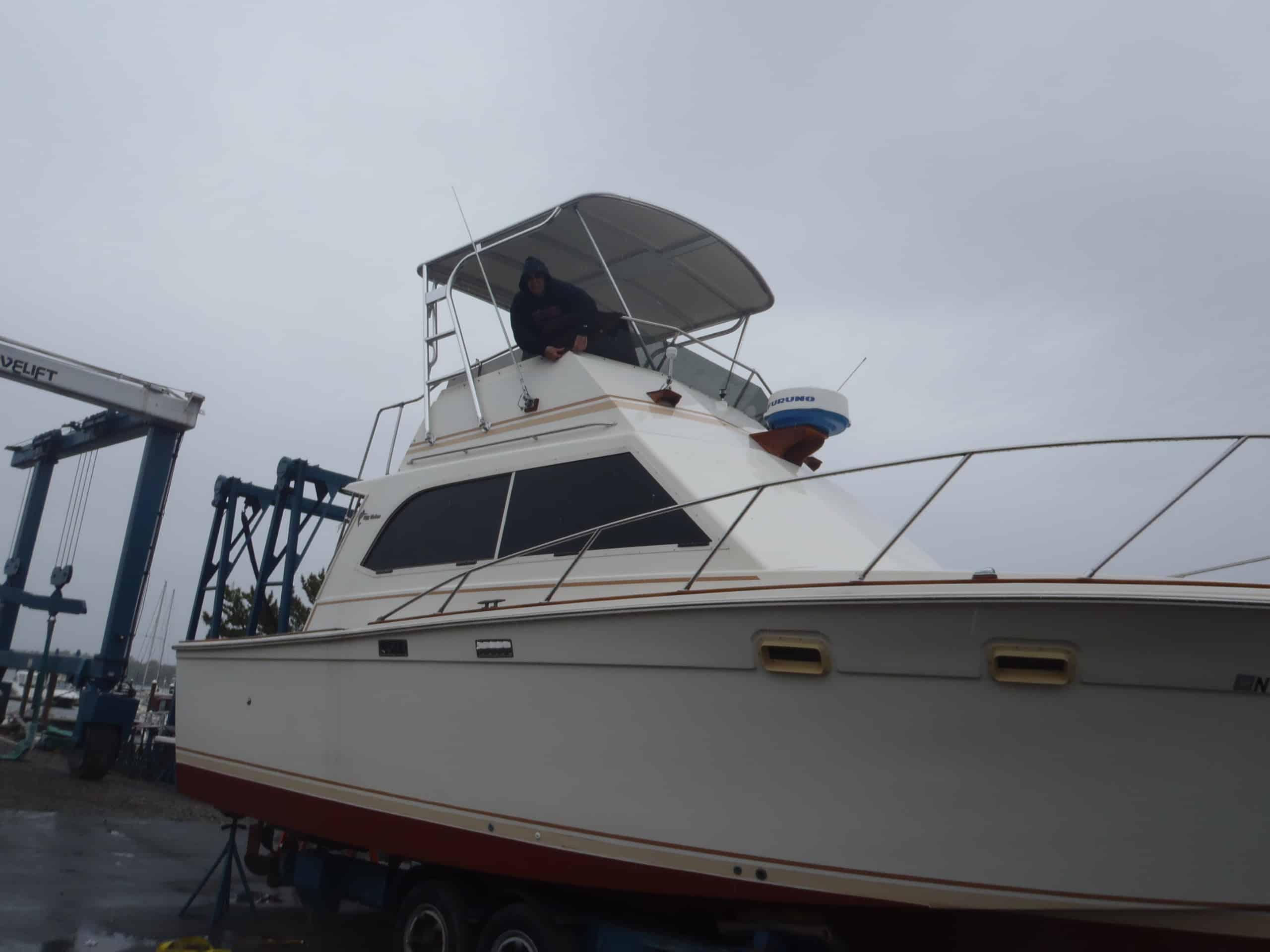 Atlantic Towers Top installed on a 1978 Egg Harbor 33 Sedan all glass convertible boat on water.