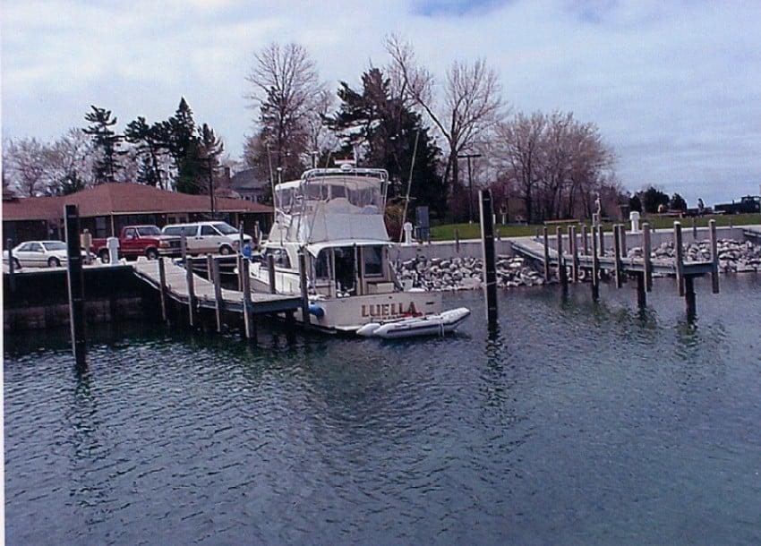 Atlantic Towers arch on a Chris Craft 360 Sport Sedan docked at a marina with a calm water view.