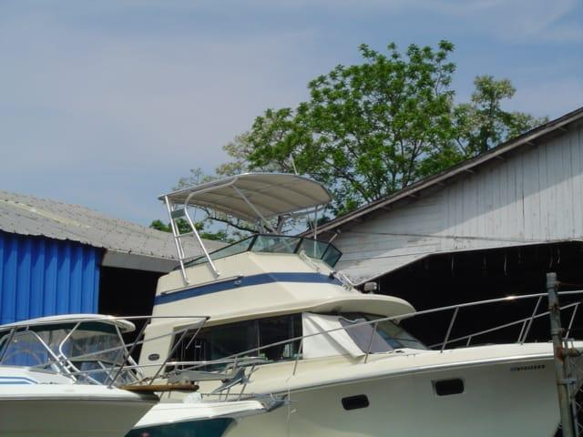 Atlantic Towers Top installed on the upper deck of a Baha Cruisers 33 FB boat docked near buildings.