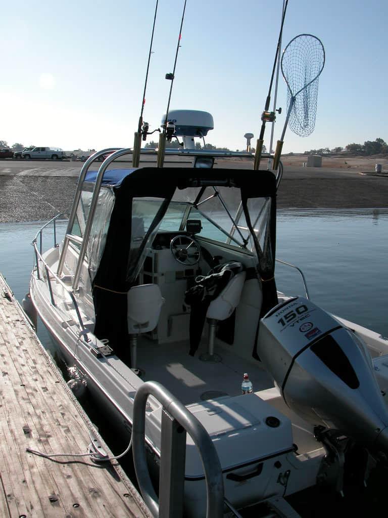Atlantic Towers Arch installed on a Seaswirl 1850 walkaround boat at the dock, featuring fishing gear and cockpit seating.
