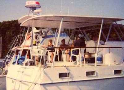 Atlantic Towers Top installed on Hattaras 41 Twin Cabin boat with people seated on the deck outdoors