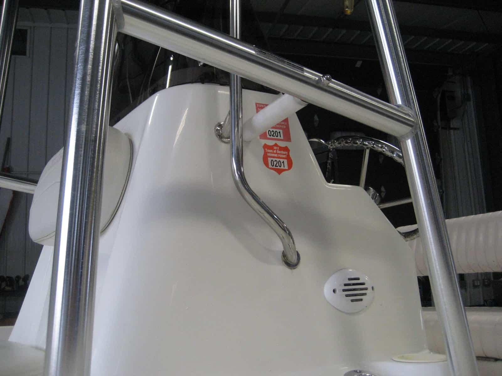 Atlantic Towers T-Top installed on a Nautic Bay 1800 center console boat shown on water with background shoreline.