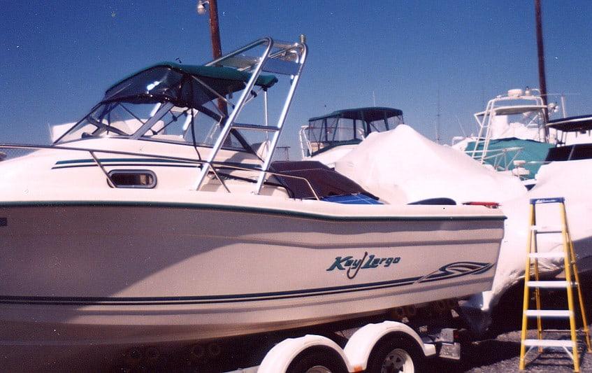 Key Largo 2200 W/A boat on trailer with installed Atlantic Towers arch and covered boats in background