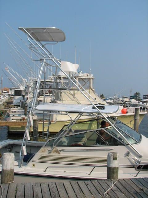 Atlantic Towers Tuna Tower installed on a Boston Whaler 31 Sortfish at a marina with multiple boats visible.