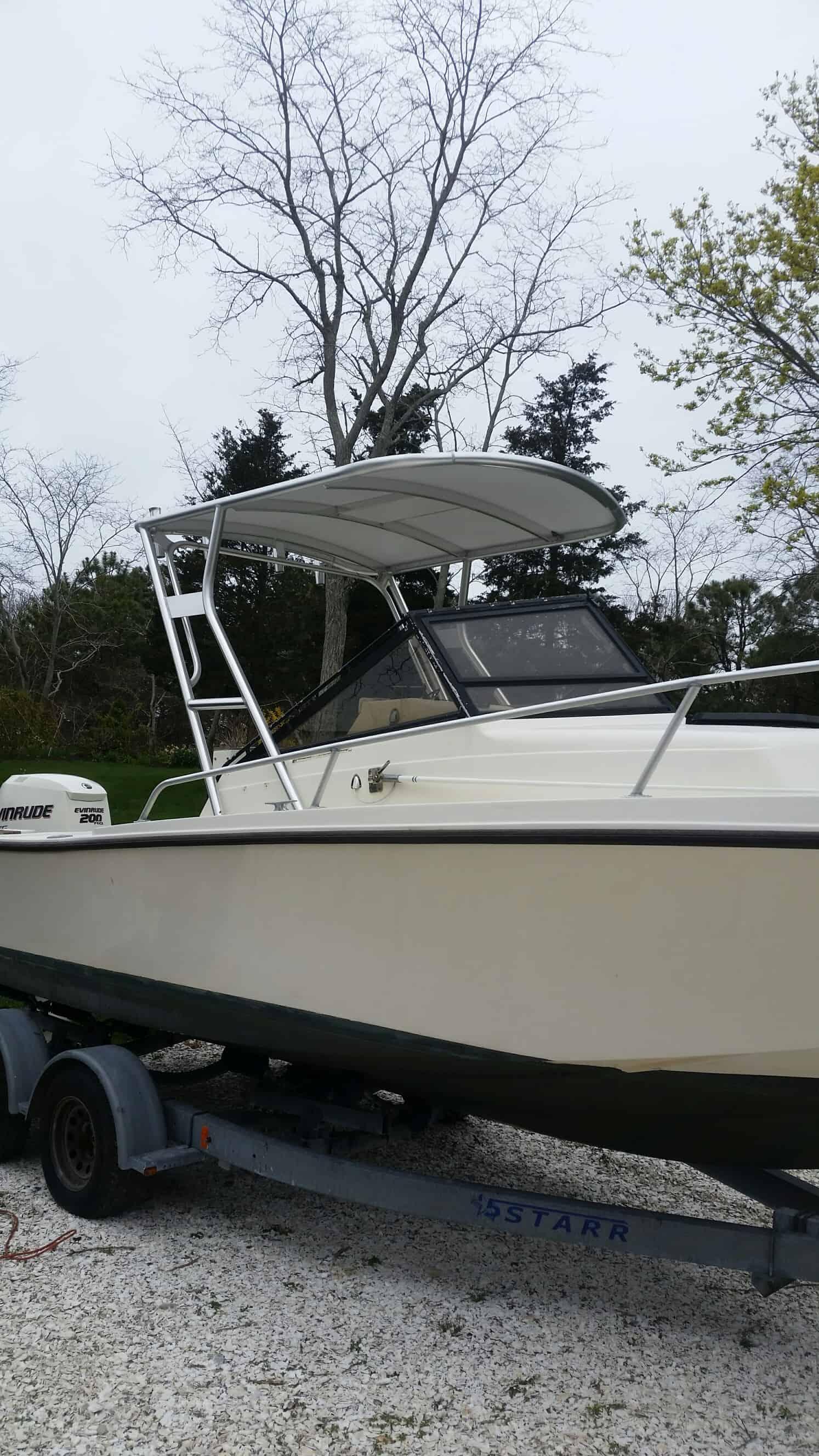 Atlantic Towers Top installed on a Mako boat, featuring a white hull and a trailer in a natural setting.