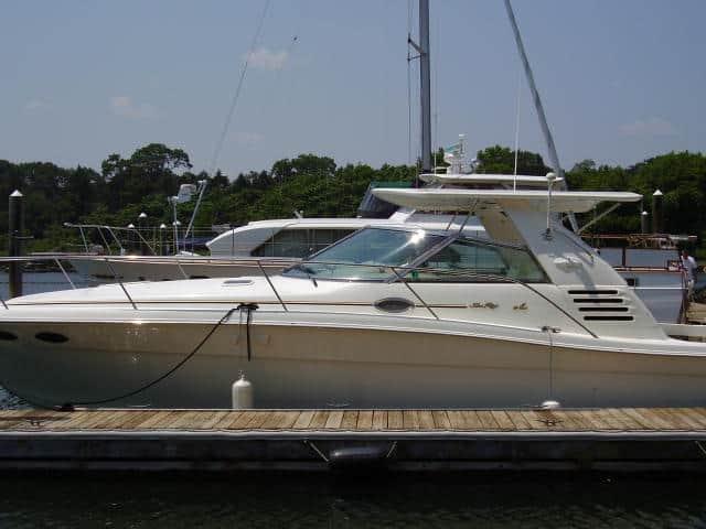 Sea Ray 370 Express Cruiser boat docked with Atlantic Towers Top installed on the cabin roof under clear sky.