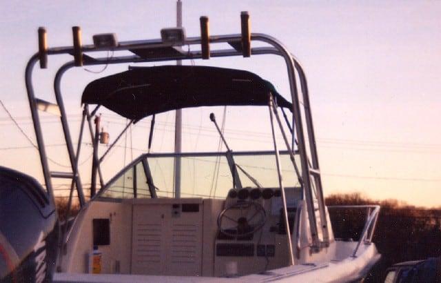 Atlantic Towers Arch installed on a Pro Line 2470 boat, showcasing the helm and canopy in a sunset setting.